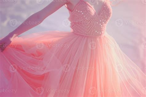 A woman elegantly spins in a light pink gown adorned with delicate