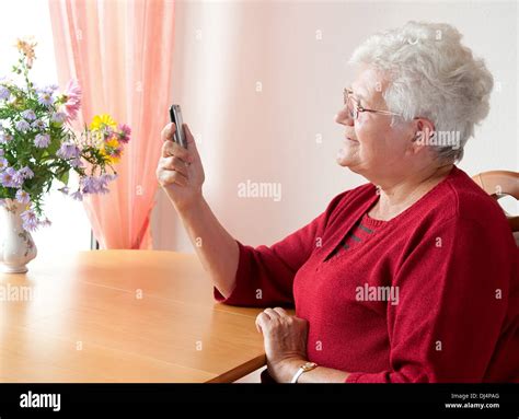 old woman reading a sms Stock Photo - Alamy
