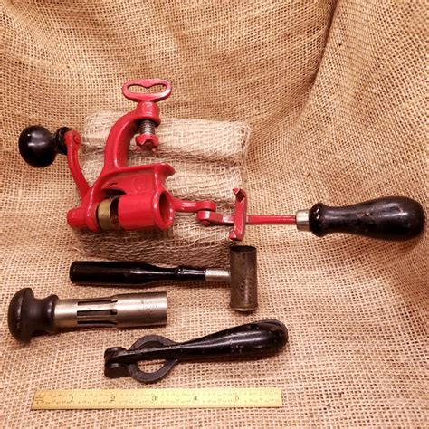 red vintage hand reloading shotgun shell press including accessories