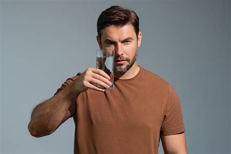 guy drinking water isolated  studio background man enjoy pure