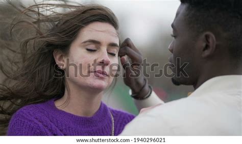 Interracial Couple Kissing Candid Tender Affection ภาพสต็อก 1940296021
