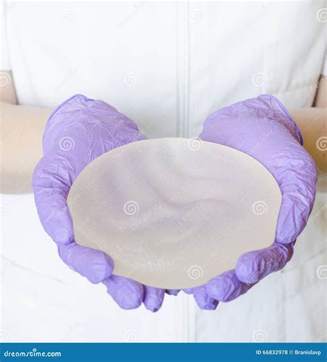 Silicone Breast Implants. Nurse Holding Implants. Doctor Holding