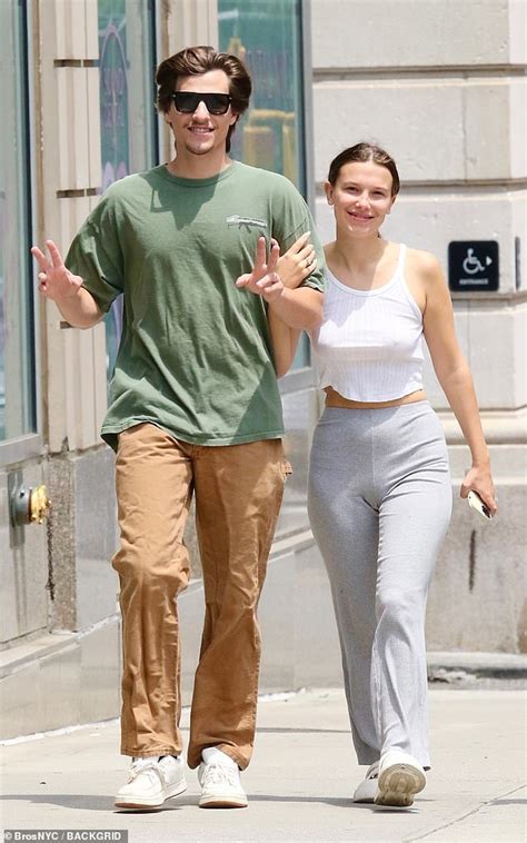 Millie Bobby Brown rocks a white crop top and gray bottoms while ...