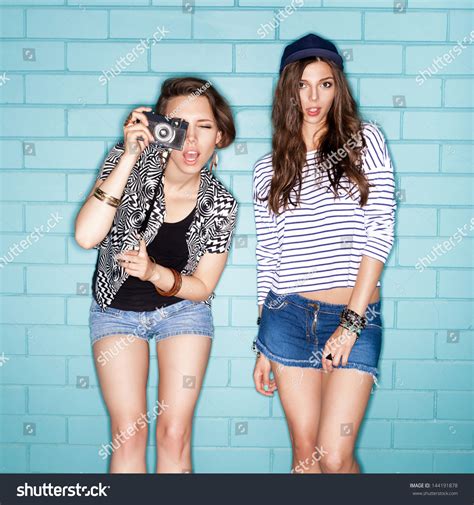 Two Young Naughty Girls Having Fun. Lifestyle Stock Photo 144191878