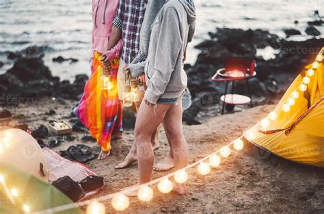 Group friends having fun camping next the sea - Happy young people