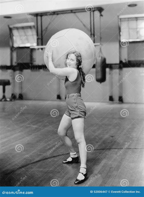 Woman in Gymnasium with Huge Ball Stock Image - Image of athletes