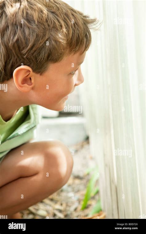 boy hiding  fence stock photo alamy