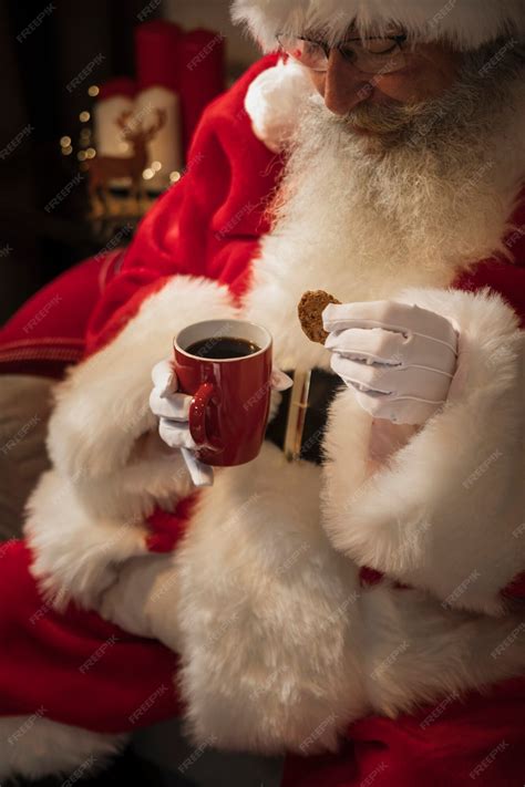 Free Photo | Santa claus drinking a cup of coffee