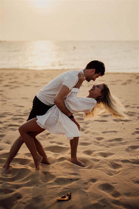 Download Couple At Beach Playful Pose Wallpaper | Wallpapers.com