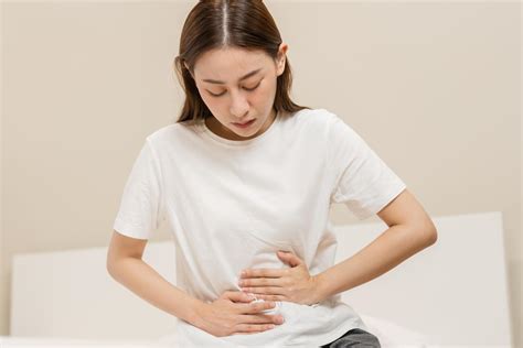Flatulence ulcer, asian young woman, girl hands in belly, stomachache