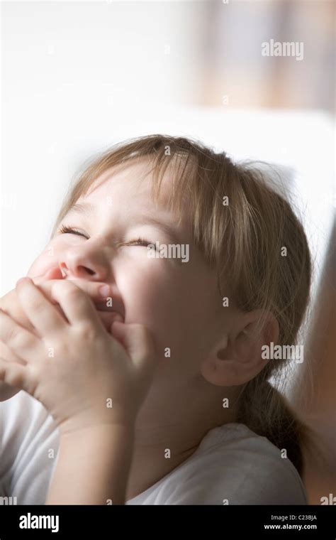 Girl laughing hands over mouth hi-res stock photography and images - Alamy