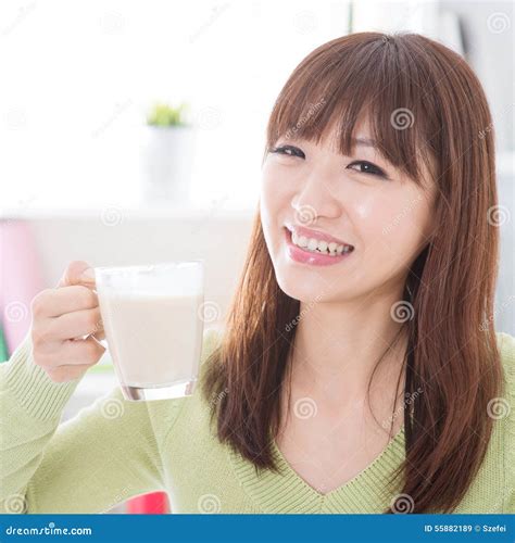 Asian Female Drinking Dairy Milk Stock Image - Image of adult, indoors