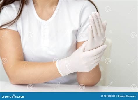 female hands putting  protective gloves stock photo image  care