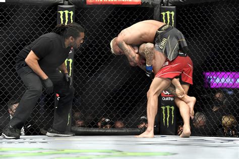 Charles Oliveira finishes Dustin Poirier with standing rear-naked choke