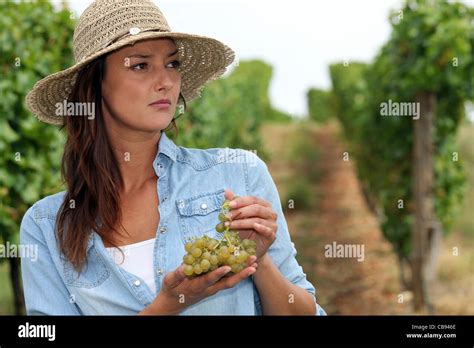 Woman eating grapes Stock Photo - Alamy
