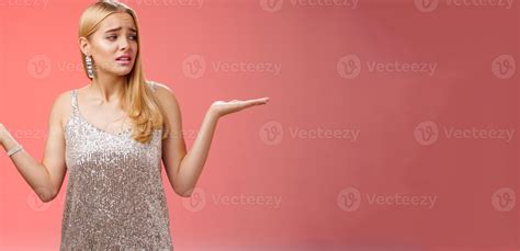 Anxious insecure young cute blond girl feel lost unsure shrugging hands