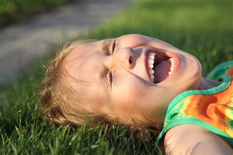 Laughing Girl Lying in Grass Stock Photo - Image of fresh, laugh: 22292940