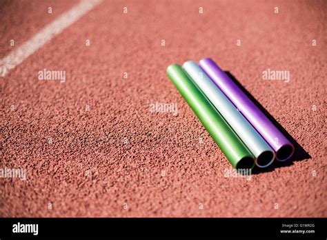 Relay baton on running track Stock Photo - Alamy