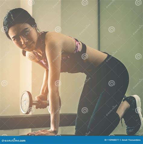 Strong Asian Skinny Woman Lifting Dumbbell in Fitness Stock Image