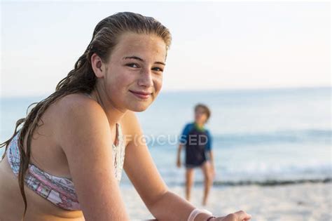 Smiling teenage girl at sandy tropical beach, Grand Cayman Island