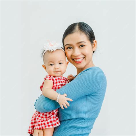 Premium Photo | Looking to camera Pretty Asian mom with baby daughter