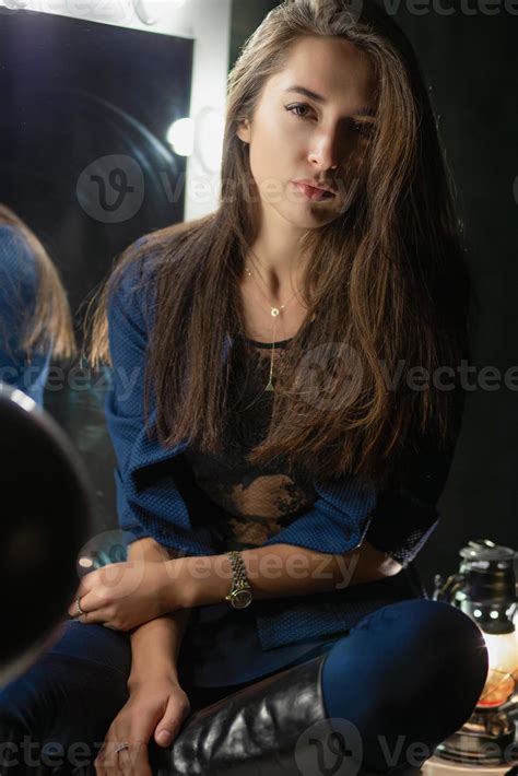 Sexy young lady posing while sitting 20056673 Stock Photo at Vecteezy