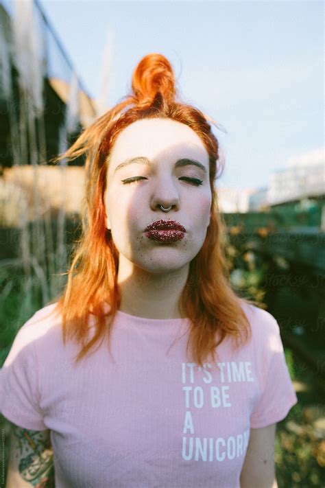 "Portrait Of A Ginger Woman With Glitter On Her Lips" by Stocksy