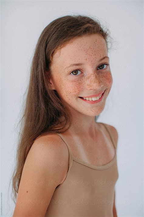 Lovely Girl With Freckles And Happy Smile Posing At Studio And Looking ...