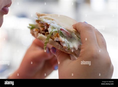Hand holding kebab Stock Photo - Alamy