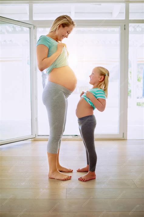 Premium Photo | Pregnant woman and child comparing stomach size for