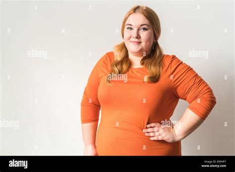 Chubby woman sport at home standing isolated on white wall looking 
