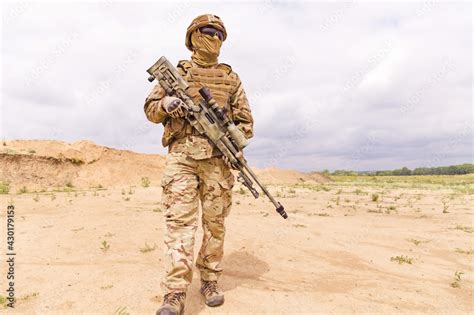 Equipped and armed special forces soldier with sniper rifle standing in ...