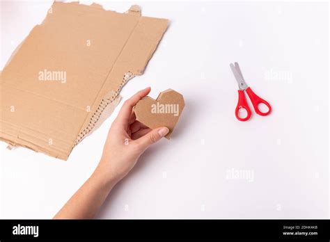hands make a valentine craft, abstract cardboard heart Stock Photo - Alamy