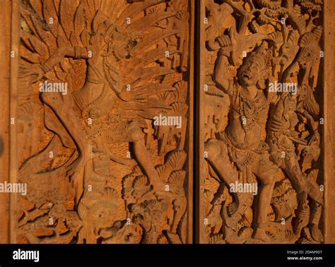 intricate wooden carving  temple doors depicting scenes  hindu