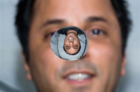 NASA astronaut Joe Acaba photographs himself in zero gravity through a
