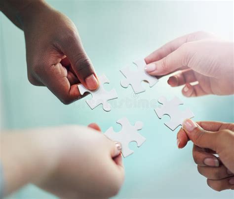 figured  hands putting puzzle pieces