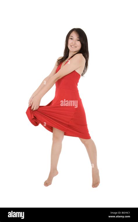 Beautiful Asian woman in a red sun dress posing on a white background ...
