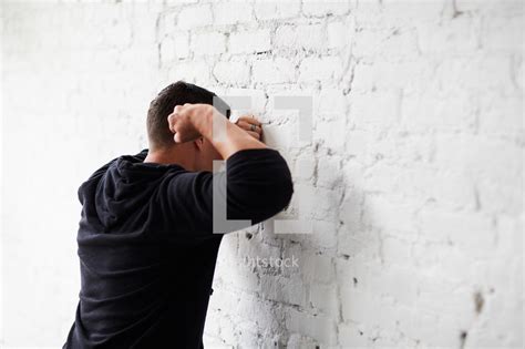 man beating  fists   wall photo lightstock