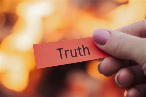Premium Photo | Paper with inscription truth in woman's hand with fire ...