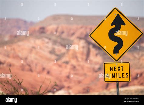 Road sign explaing that next four miles comes winding road Stock Photo ...