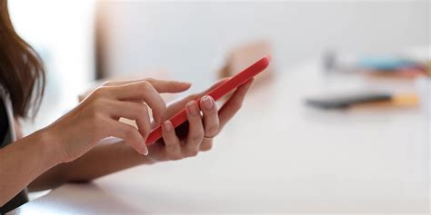 Close up of woman holding smartphone, typing message, texting, chatting