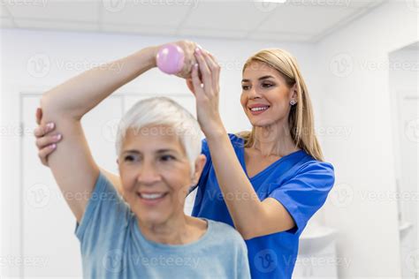 Professional therapists is stretching muscles, senior patient with