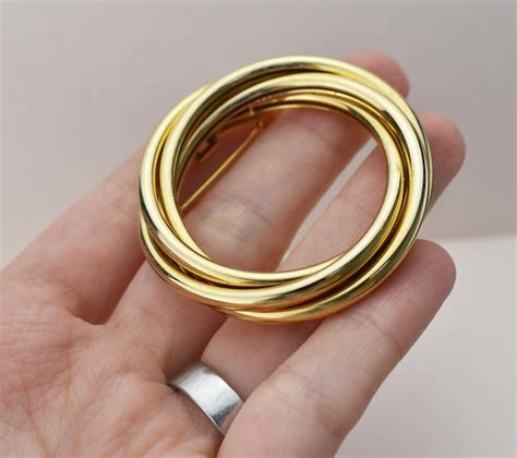 premium photo gold brooch   white background  hand