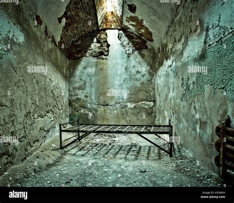 Crumbling abandoned prison cell with cot Stock Photo, Royalty Free ...