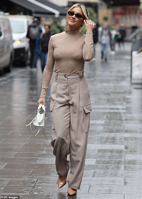 Amanda Holden gets caught in a blustery wind as she departs Heart Radio