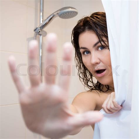 pretty woman hiding behind shower curtain | Stock image | Colourbox