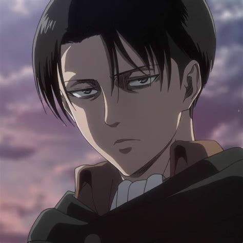 a man with black hair and blue eyes staring at the camera in front of ...