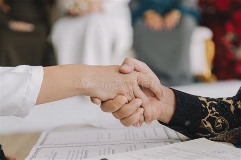 groom shaking hands  nikah ceremony stock photo image