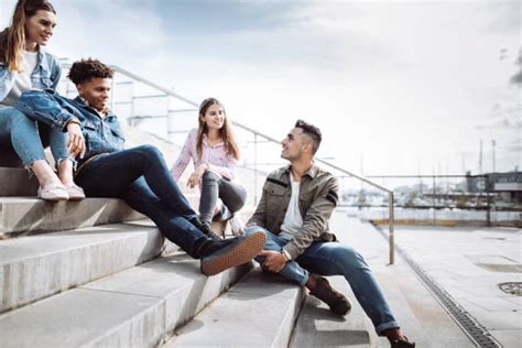 group  friends sitting  bench stock  pictures