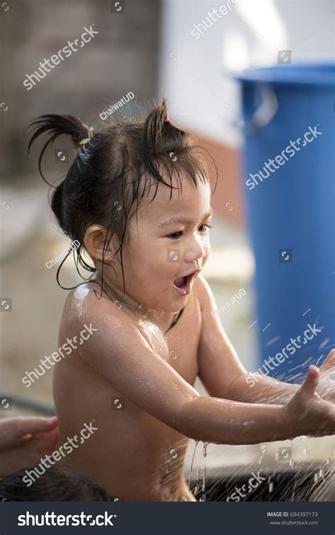 asian children bathing happily children play stock photo